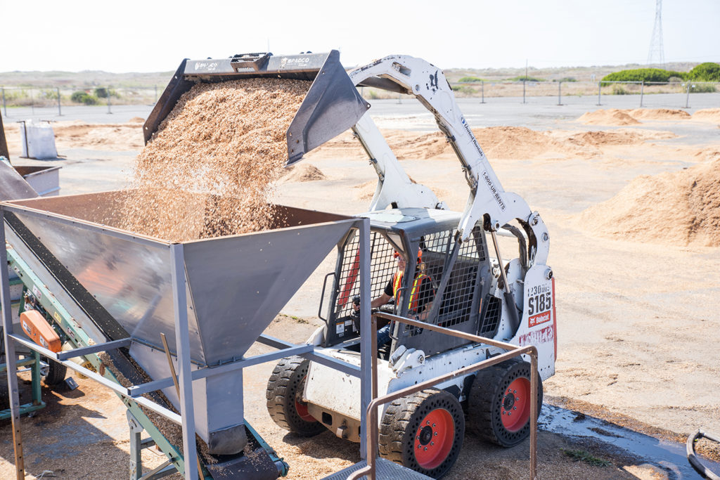 Wood chips are deposited into a processor