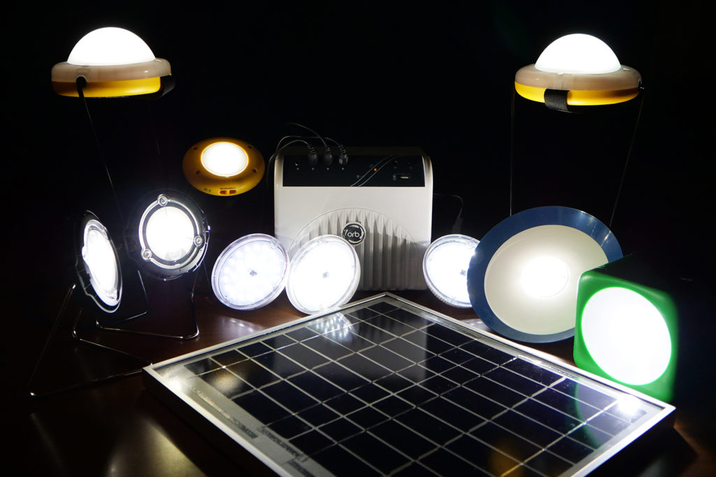 An array of various solar lights and lanterns, and a small solar module