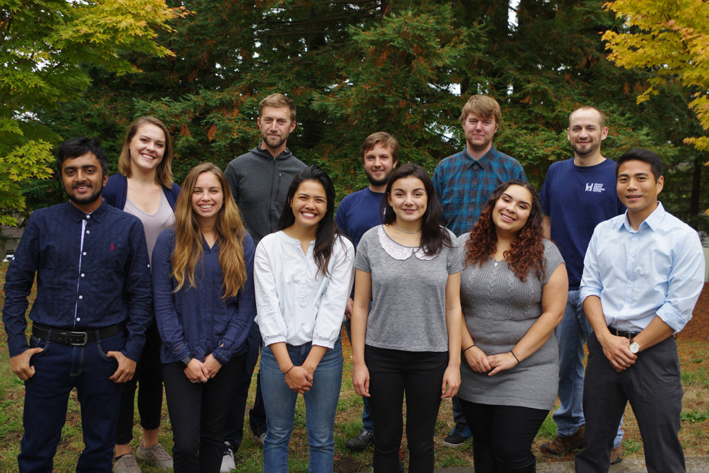 Eleven students stand in a group