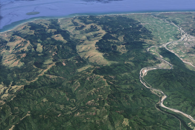 Aerial shot of mountains, with Highway 101 and the town of Scotia to the left, and the Pacific Ocean to the north
