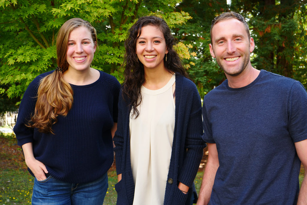 Three students stand together