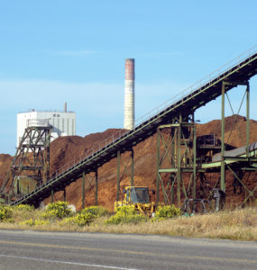 View of biomass pile and smokestack