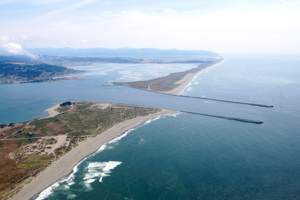 Aerial image of south Humboldt Bay and its jetties, extending into the Pacific