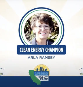 A smiling woman with the caption "Clean Energy Champion: Arla Ramsey" beneath her photo.