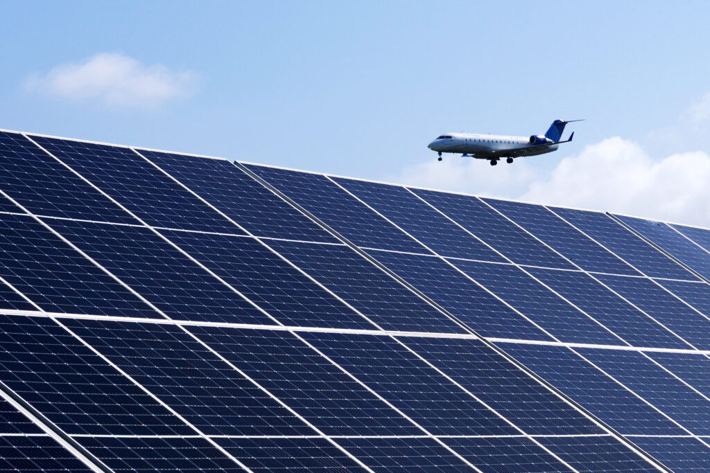 An airplane flies above the microgrid's solar array