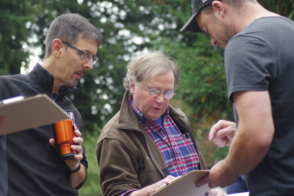 Jim, Charles and Ray consult the module layout plan