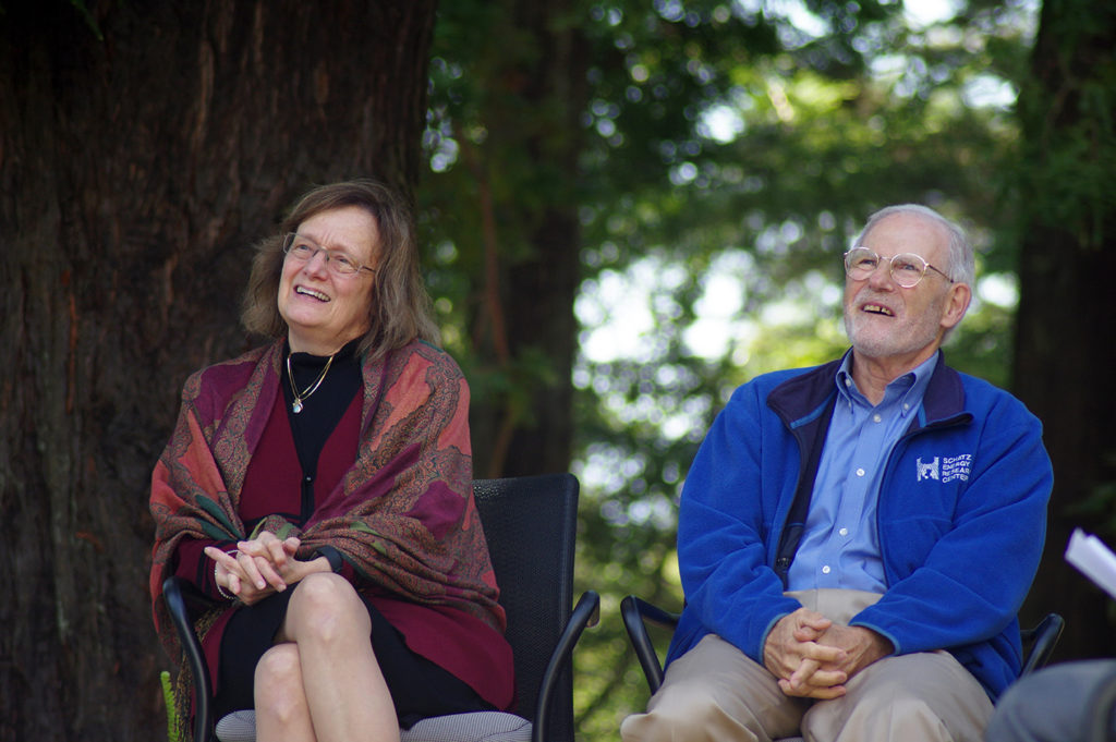 President Rossbacher and Peter Lehman sit beneath redwood trees