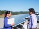 Two student observers stand at the foot of the array