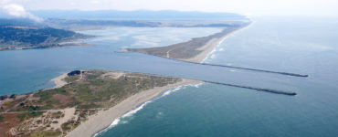 Aerial image of south Humboldt Bay and its jetties, extending into the Pacific