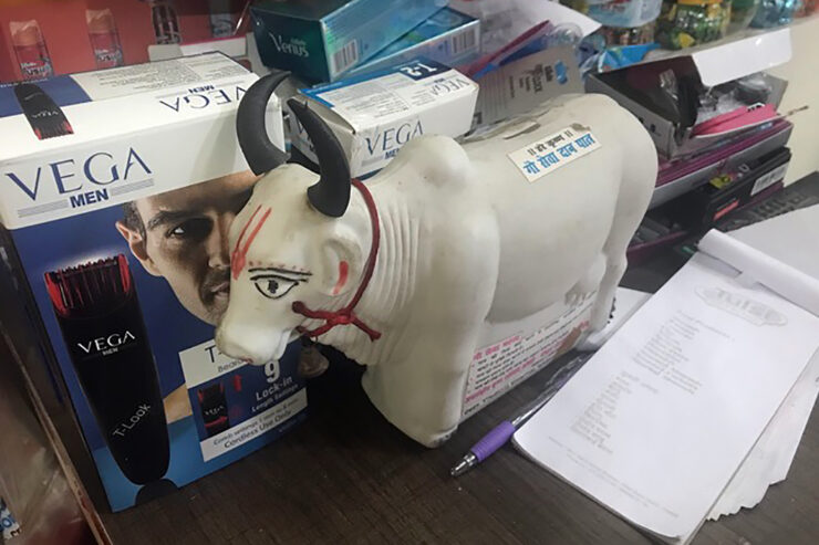 A plastic cow sits in front of mens' body products