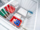 Vials inside a top-loading vaccine refrigerator