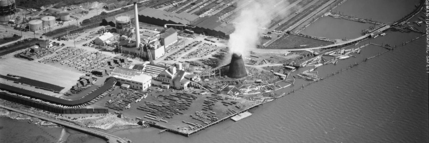Black and white aerial photo of a power plant and lumber mill on Humboldt Bay