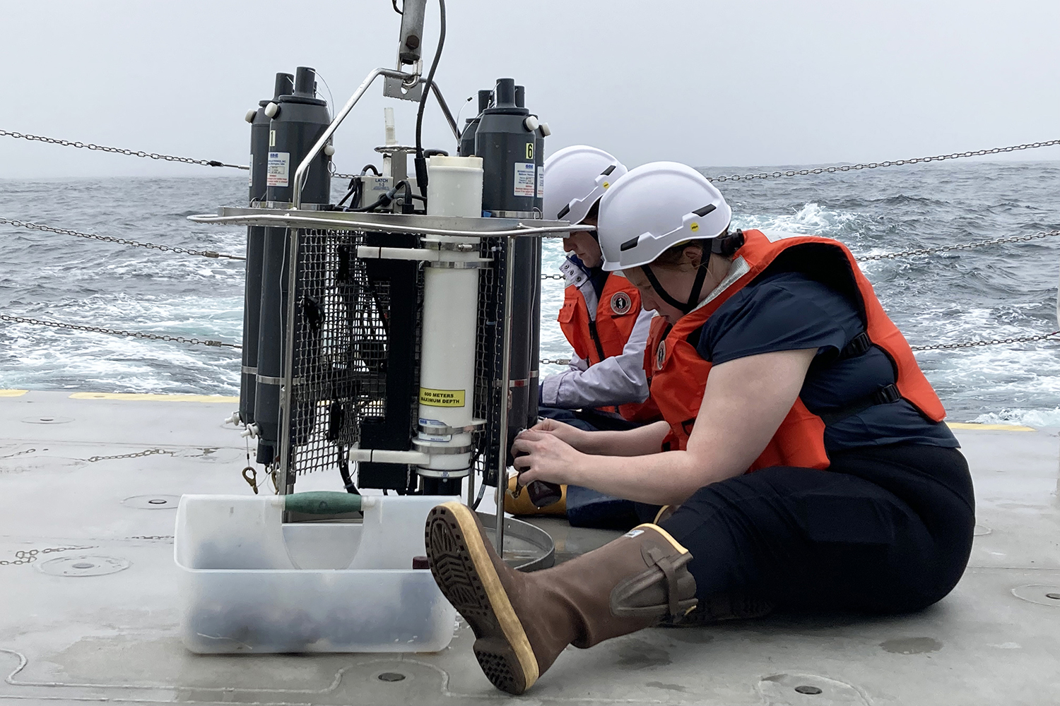 Researchers work with water samples on the deck of the North Wind